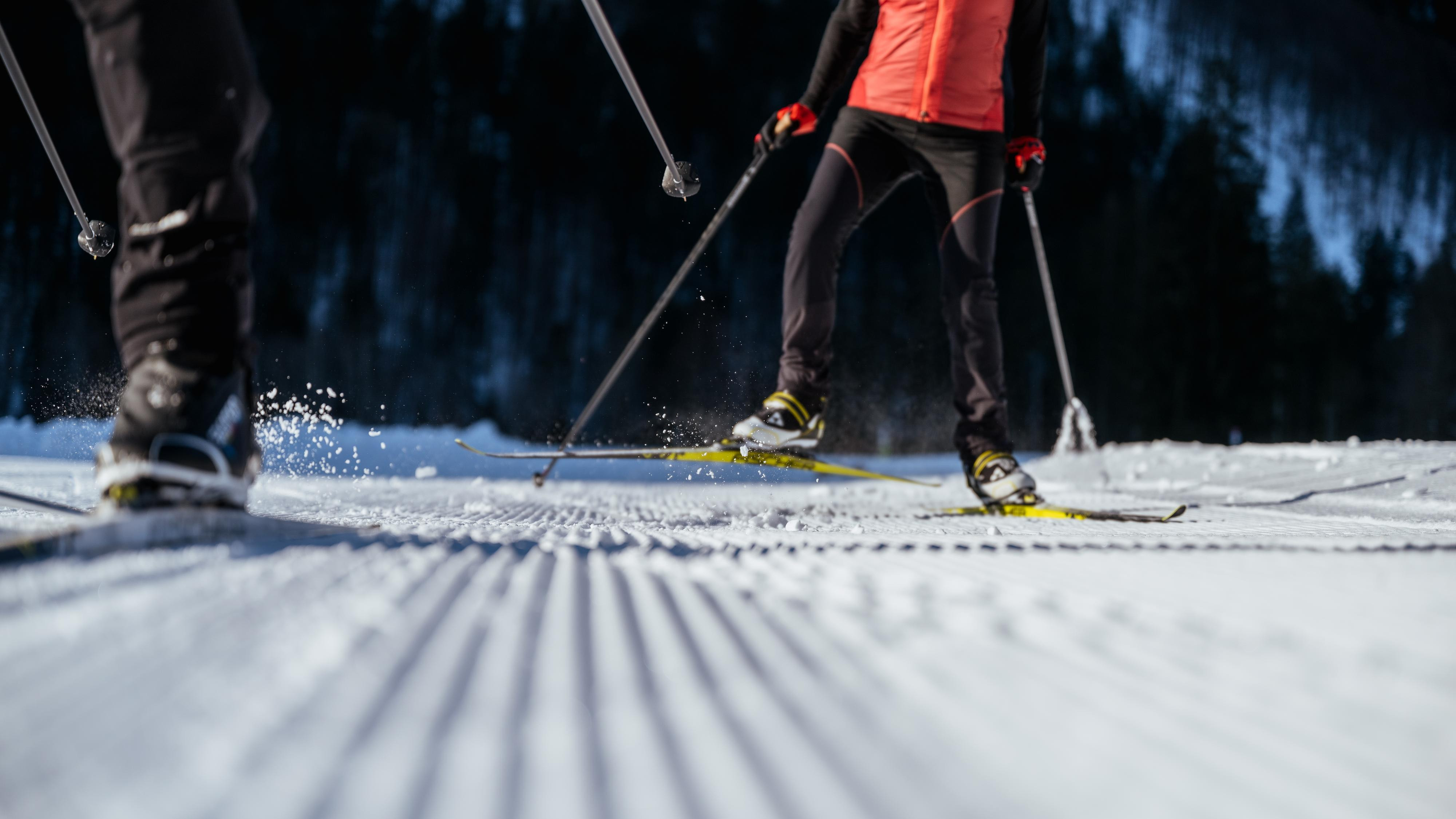 Skiers enjoying winter sports on a snowy trail in Fuschlsee.